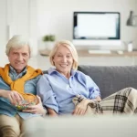 modern-senior-couple-watching-tv-MOBILE