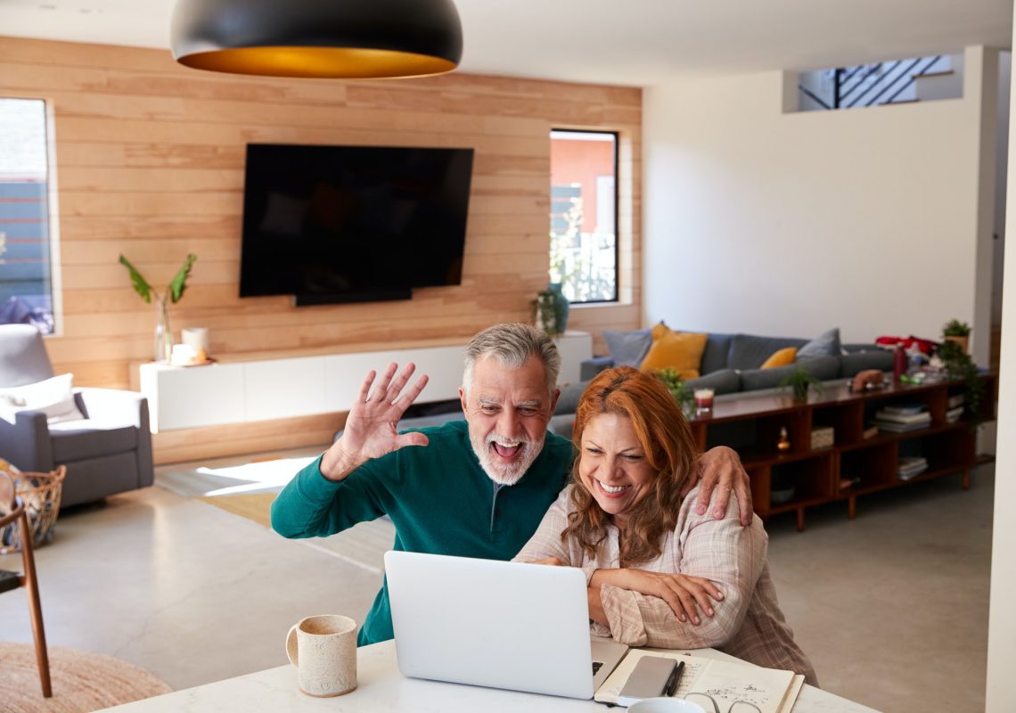 senior-hispanic-couple-at-home-with-laptop-having-video-chat-with-family.jpg